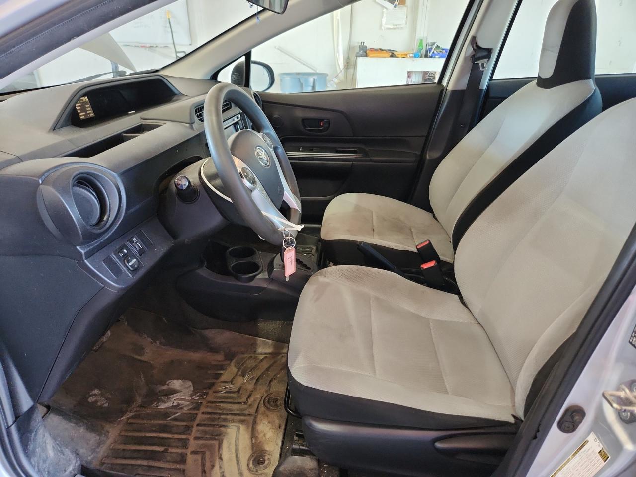 2015 Toyota Prius C One Silver vin: JTDKDTB34F1105357 Damage: Left Front Seat Cushion, Stained, Permanent