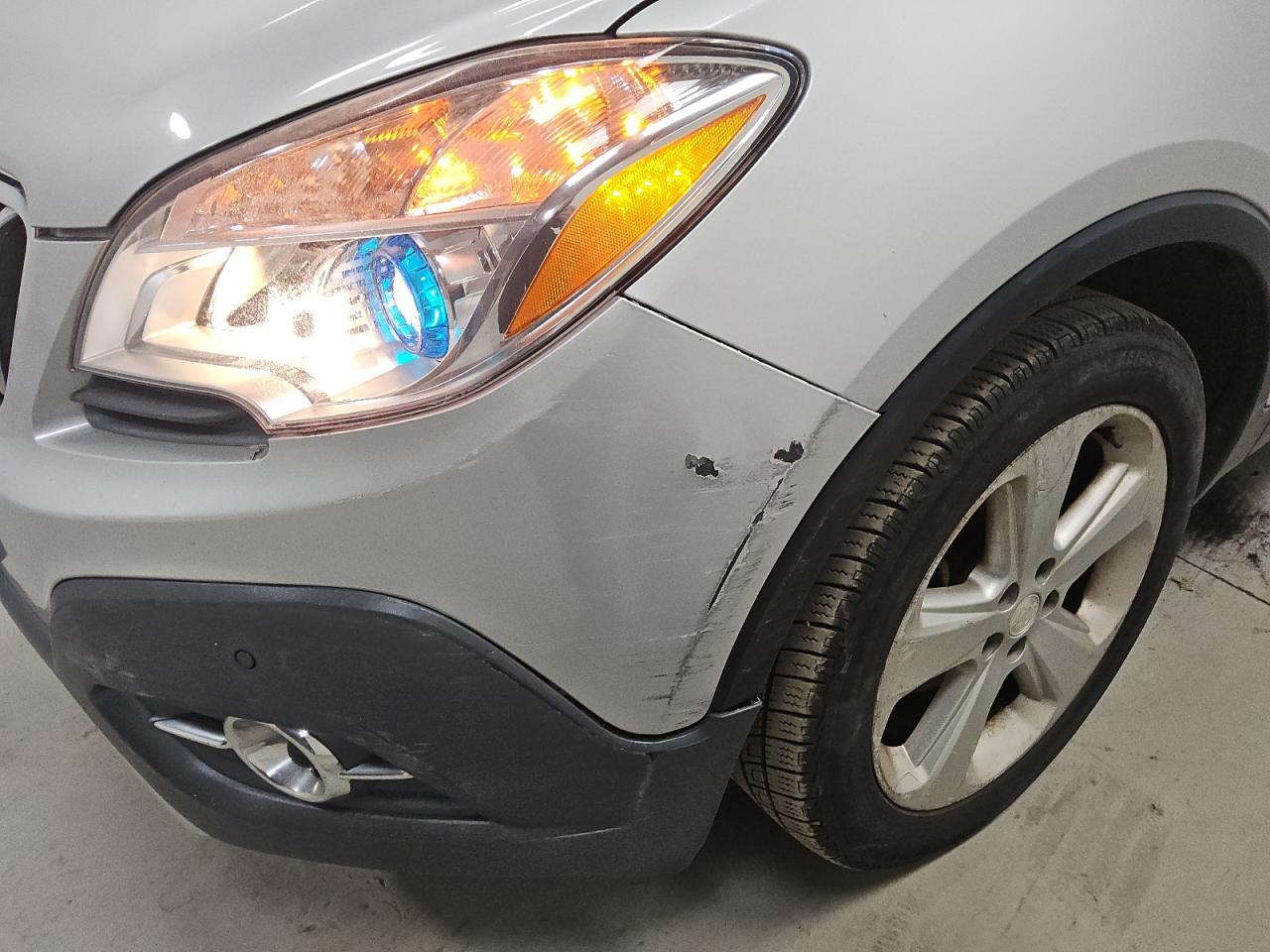 2015 Buick Encore Premium Silver vin: KL4CJDSB3FB260447 Damage: Front Bumper Molding, Multiple Scratches Heavy, Replacement Required