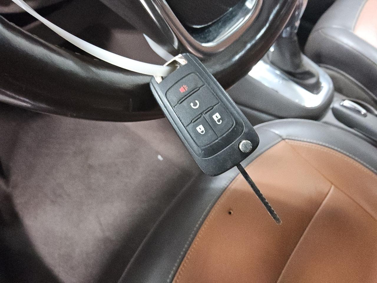 2015 Buick Encore Premium Brown vin: KL4CJHSB0FB060682 Damage: Left Front Seat Cushion, Burn Hole, 1/8 To 1/2 Inch
