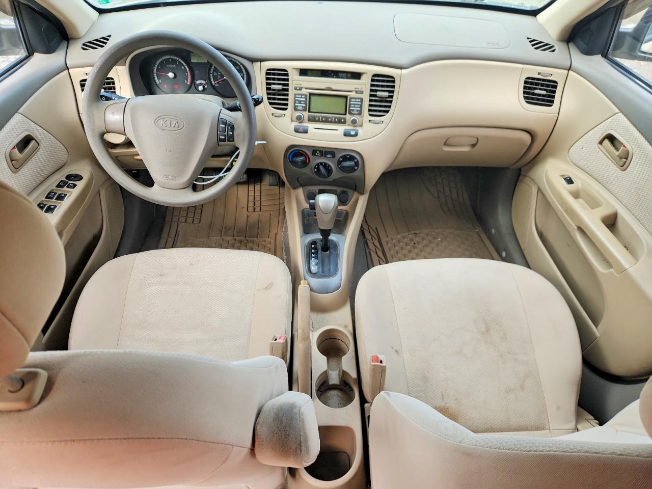 2009 Kia Rio Base Tan vin: KNADE223296538602