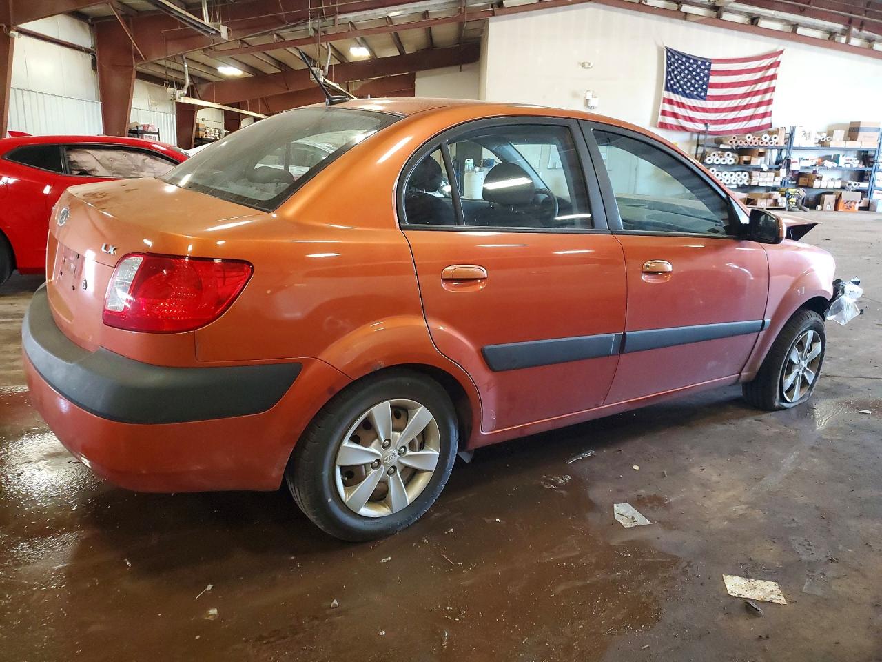 2009 Kia Rio Base Orange vin: KNADE223496459481