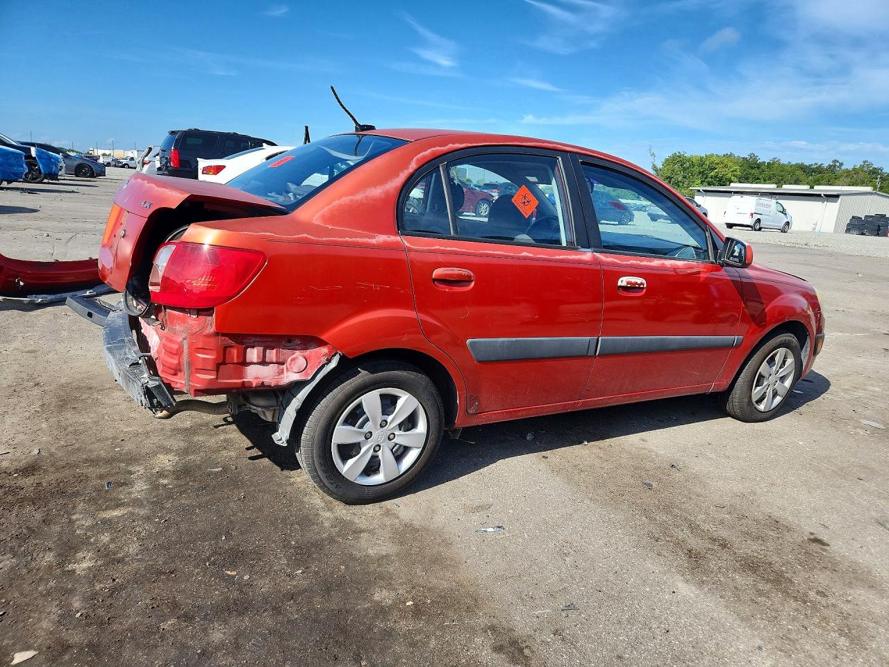 2009 Kia Rio Base Orange vin: KNADE223896447463