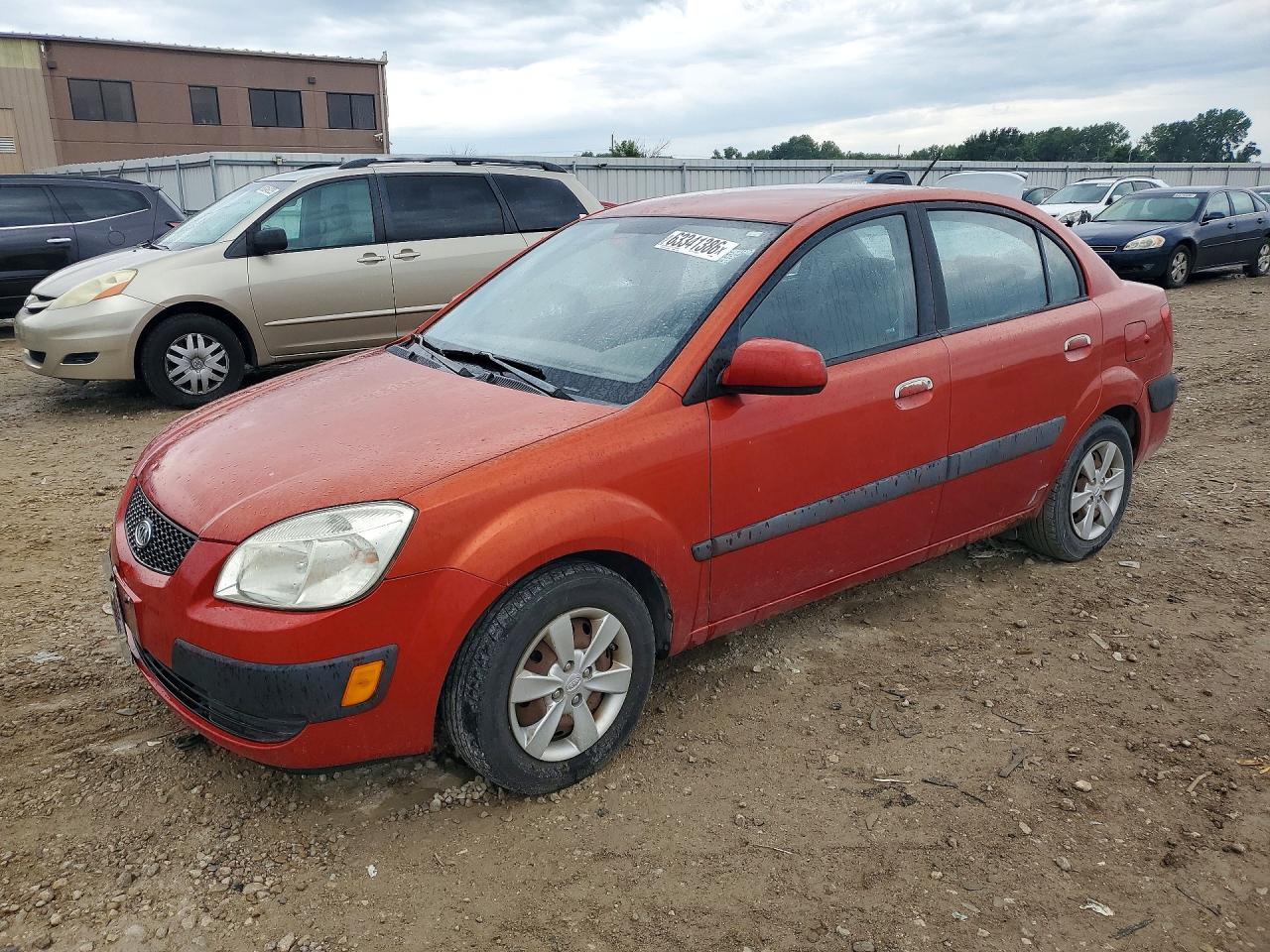 2009 Kia Rio Base Orange vin: KNADE223996499071