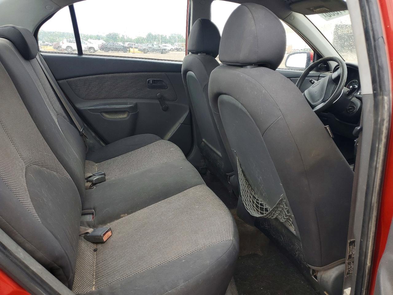 2009 Kia Rio Base Orange vin: KNADE223996499071