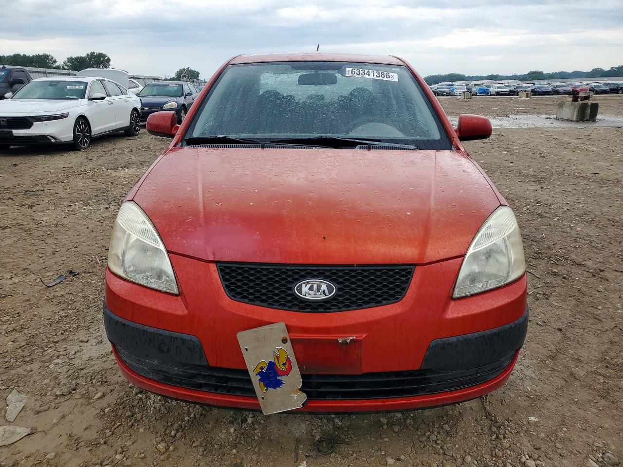 2009 Kia Rio Base Orange vin: KNADE223996499071