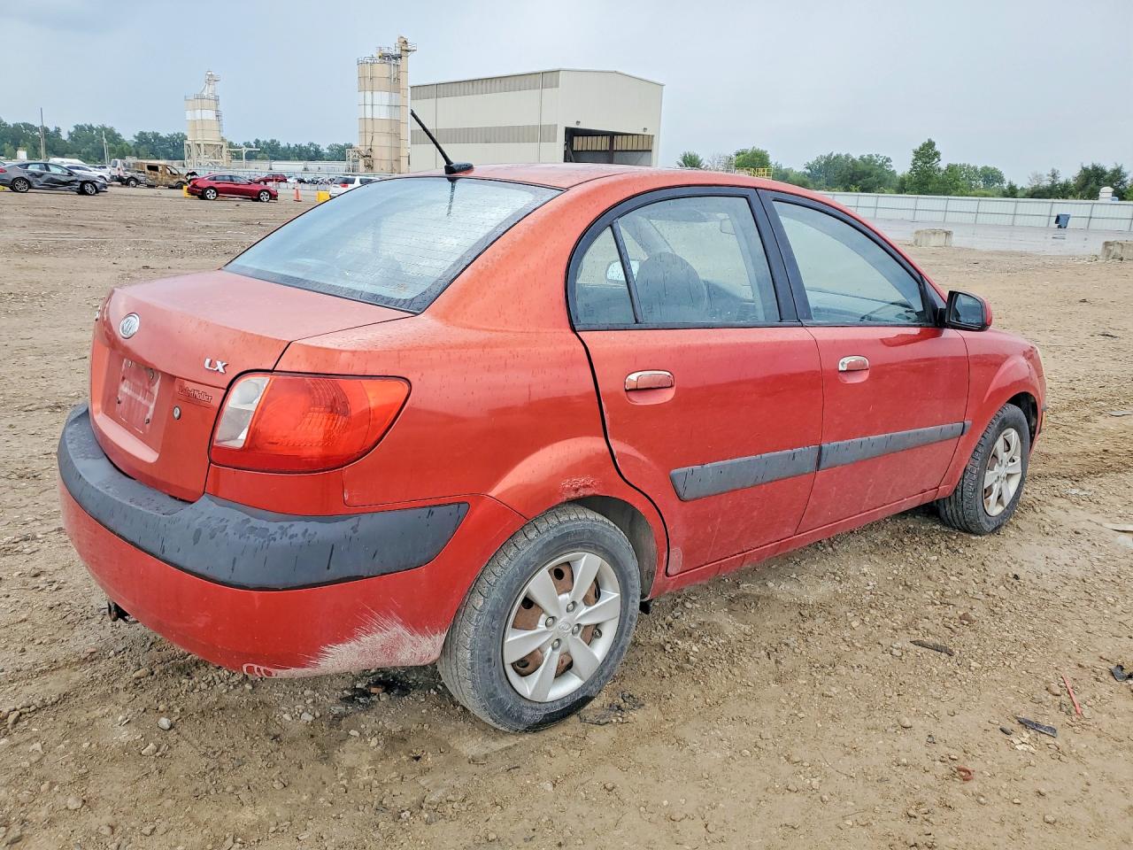 2009 Kia Rio Base Orange vin: KNADE223996499071