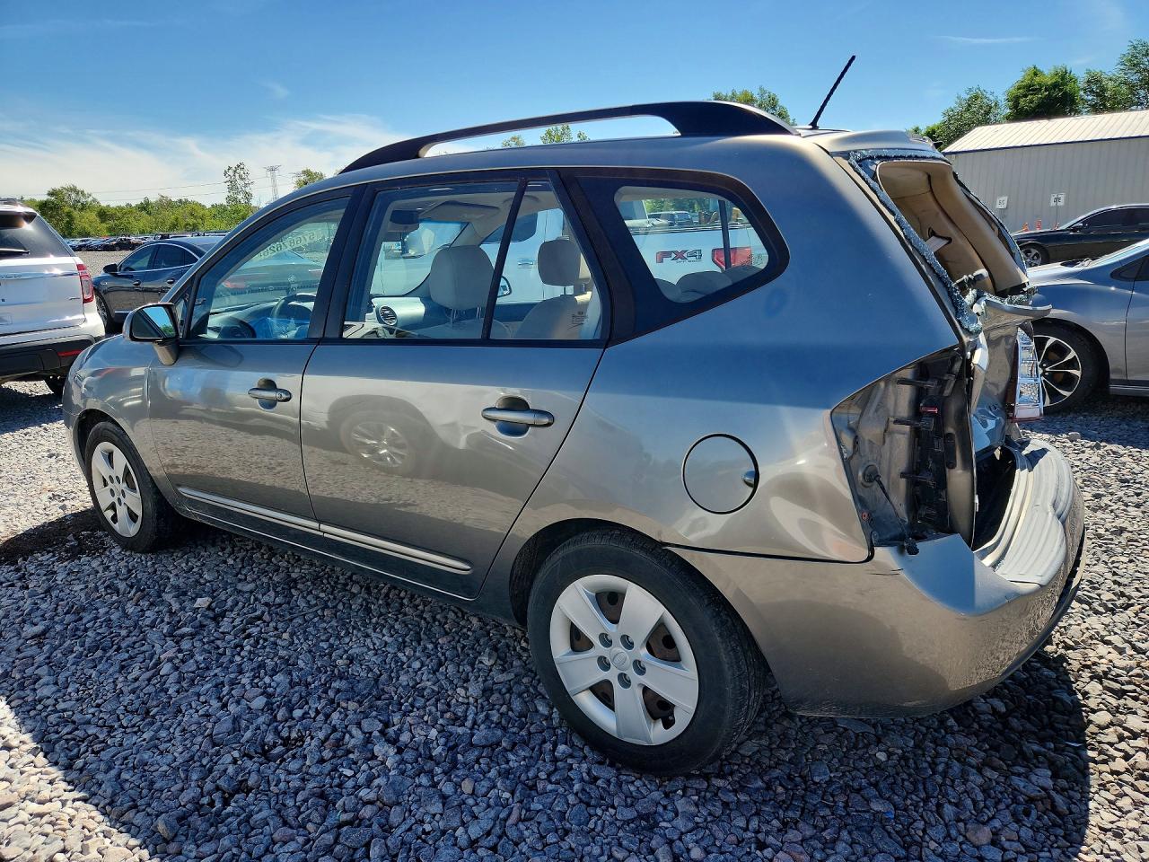 2009 Kia Rondo Base Желто-коричневый vin: KNAFG528297278664