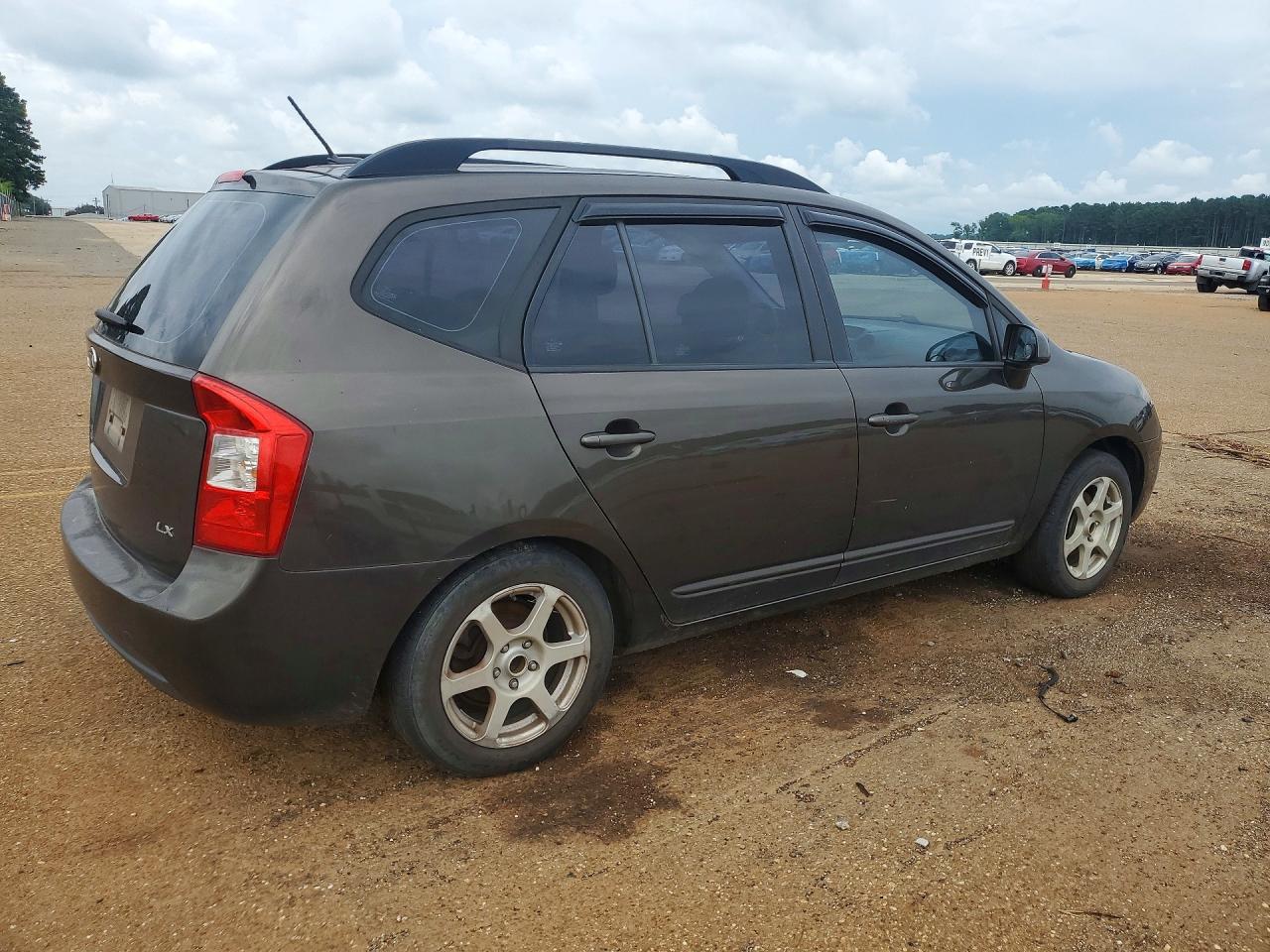 2009 Kia Rondo Base Коричневый vin: KNAFG528797266171